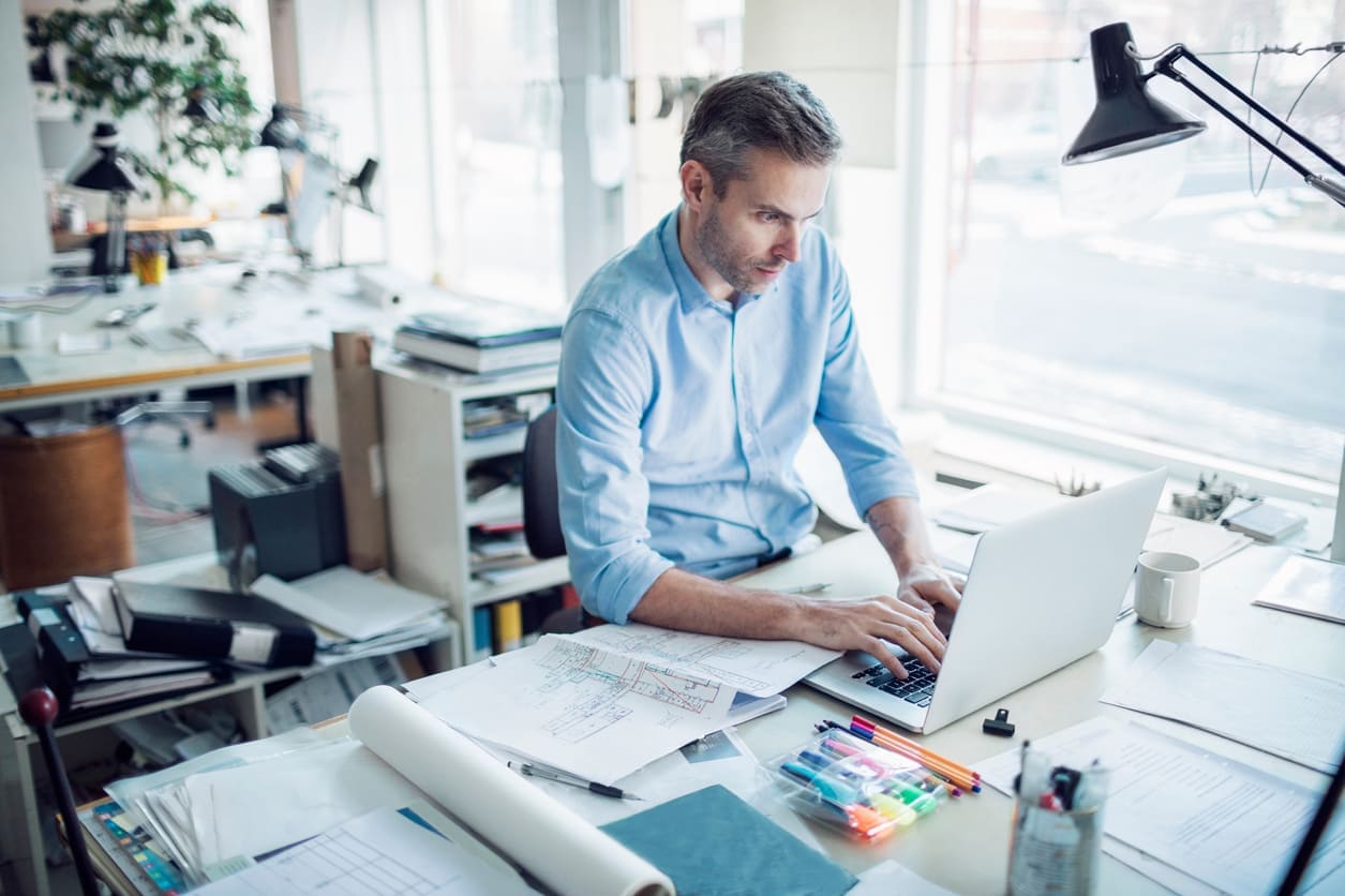 Architect working on drawings at a desk